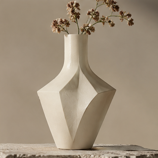 FORMIQI ivory diamond-facet geometric ceramic vase with dried flowers on stone surface, clean background