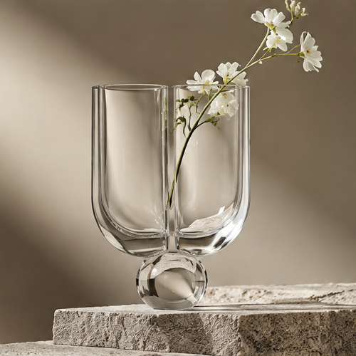 FORMIQI crystal clear twin-tube geometric glass vase with white flowers on stone surface, clean background